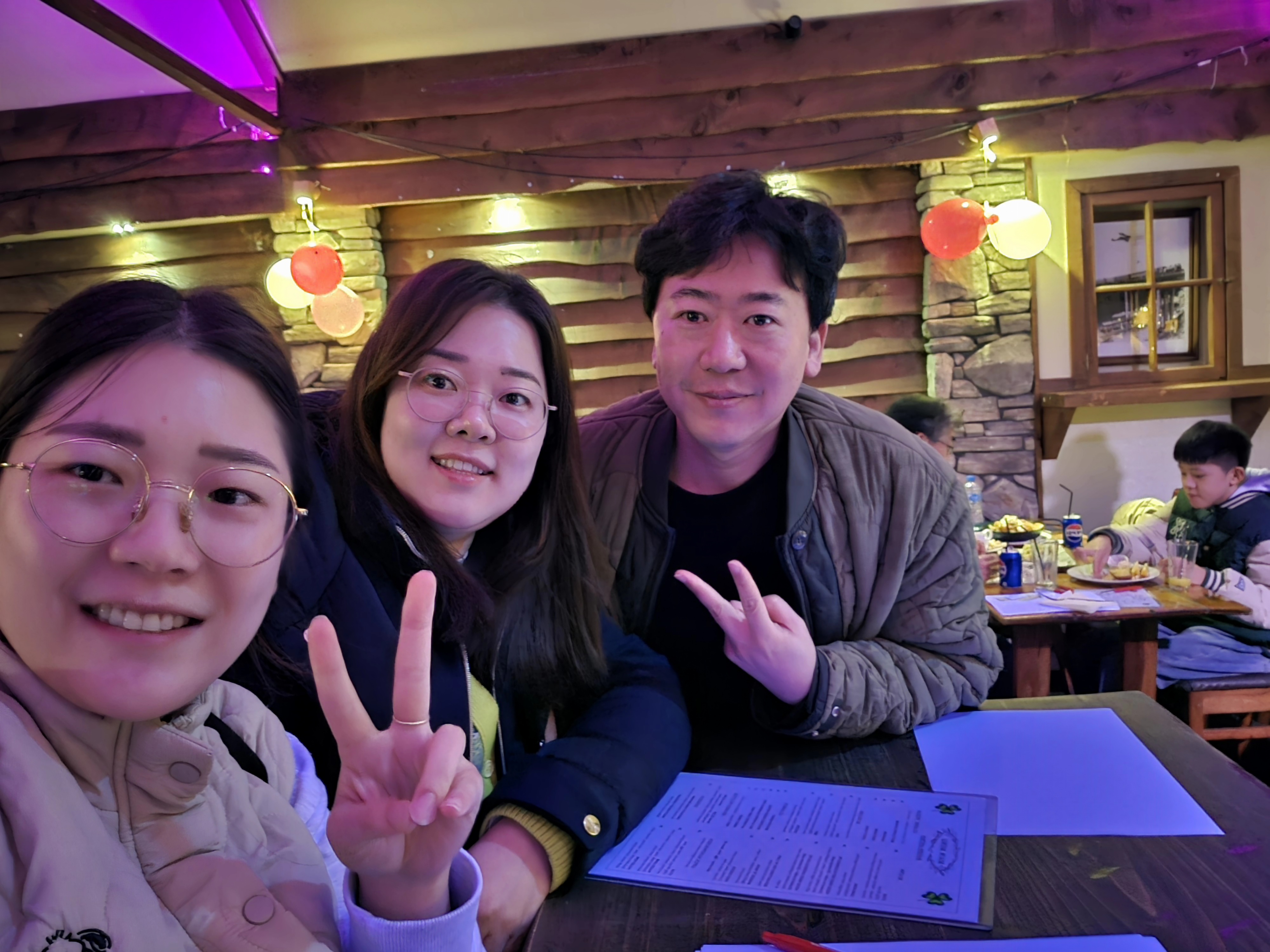 A team of one man and two women attending the Night Quiz Show.